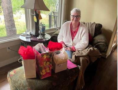 Belinda celebrating her 7dns birthday on the couch surrounded by gifts.