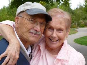 Smiling grandparents embracing.